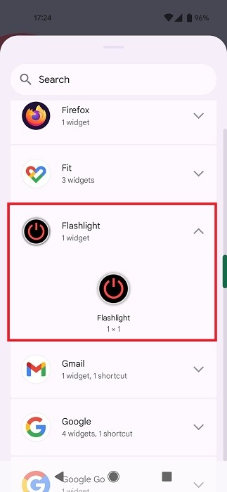 Selecting "Flashlight" widget from widget list on Android.