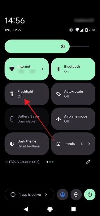Tapping on "Flashlight" tile in Android's Quick Settings. 