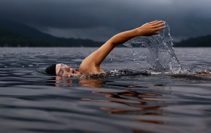 Person swimming in a lake.
