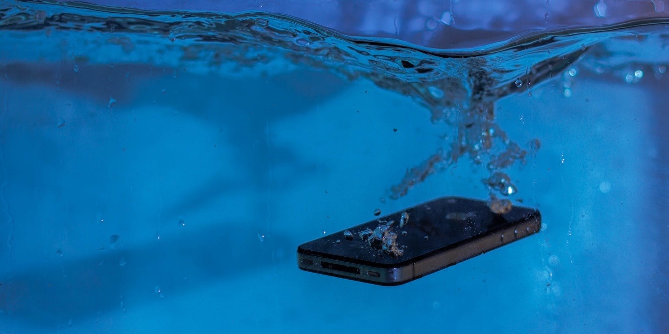 Black mobile phone inside water