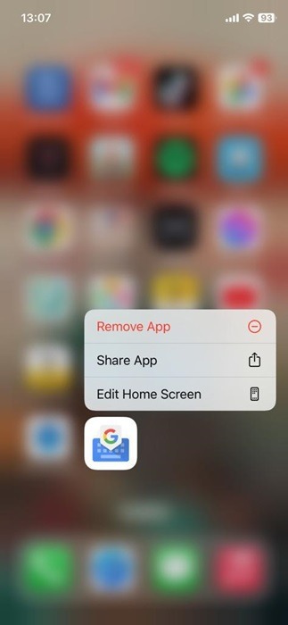 Tapping on "Remove App" option after long-pressing on Gboard app on iOS.