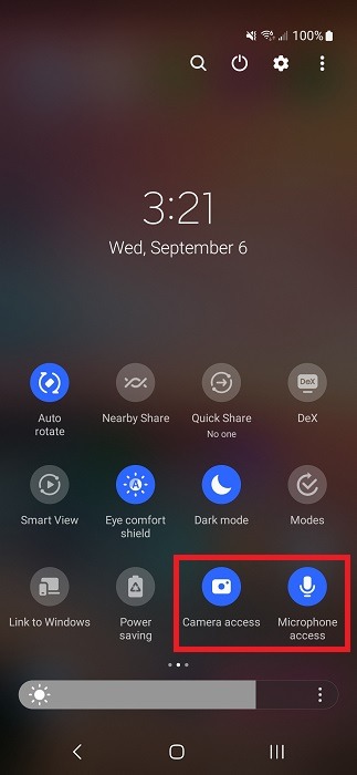 Revealing the "Camera access" and "Microphone access" toggles in Quick Settings.