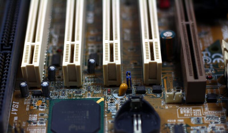 Closeup of a brown motherboard showing PCI-E slots