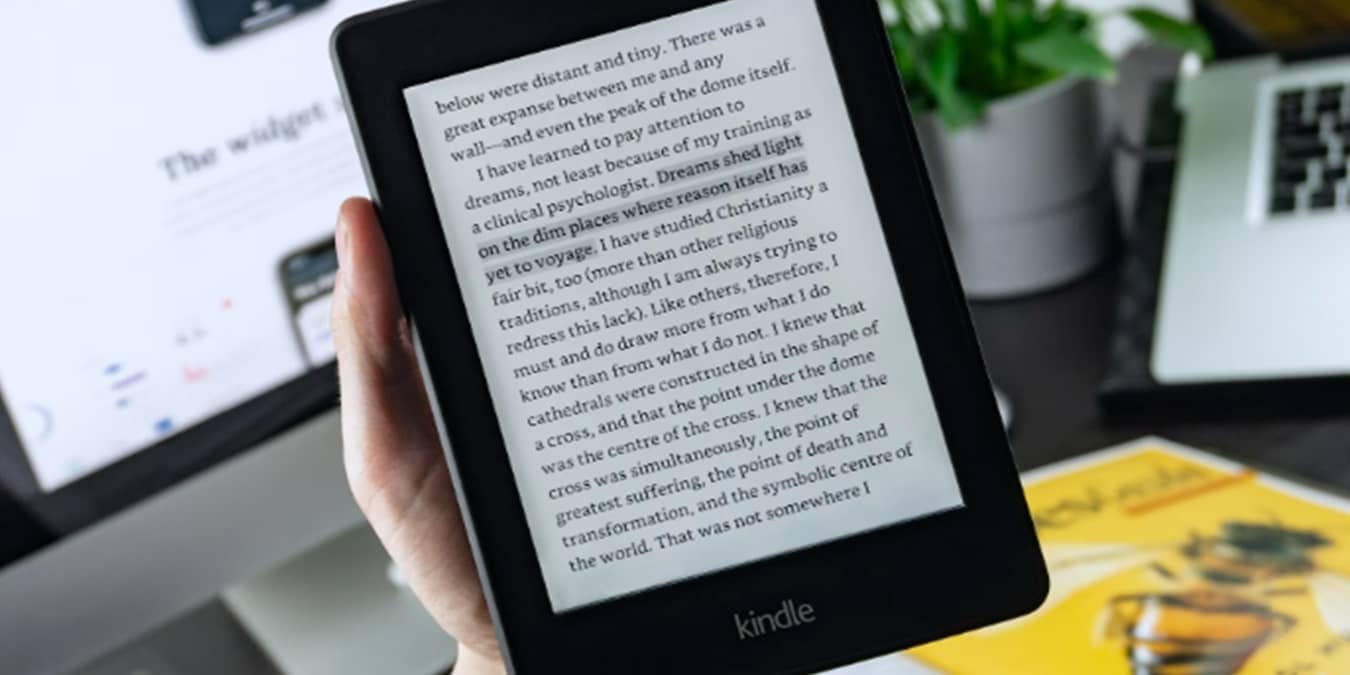 Person holding a Kindle wondering what is Kindle Unlimited.